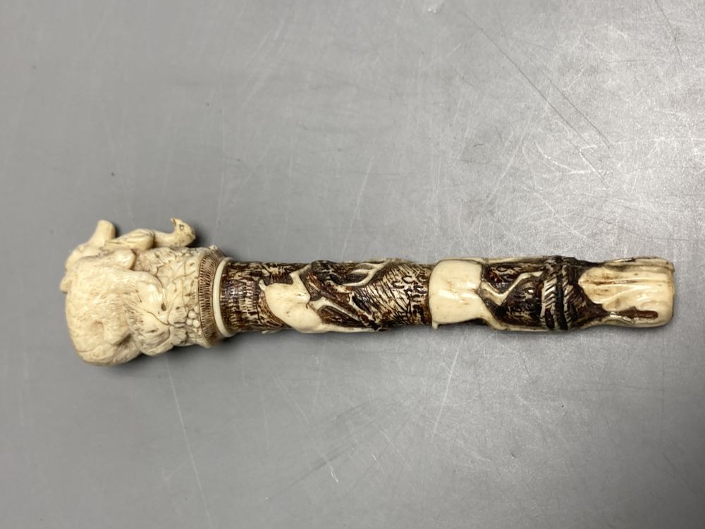 A Dieppe carved ivory pipe tamper, length 11cm